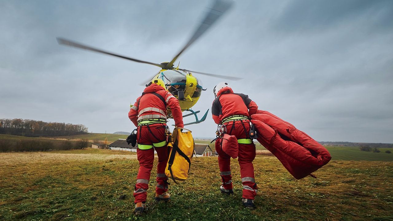 Rescue crew loading Safe Point evacuation equipment at a helicopter